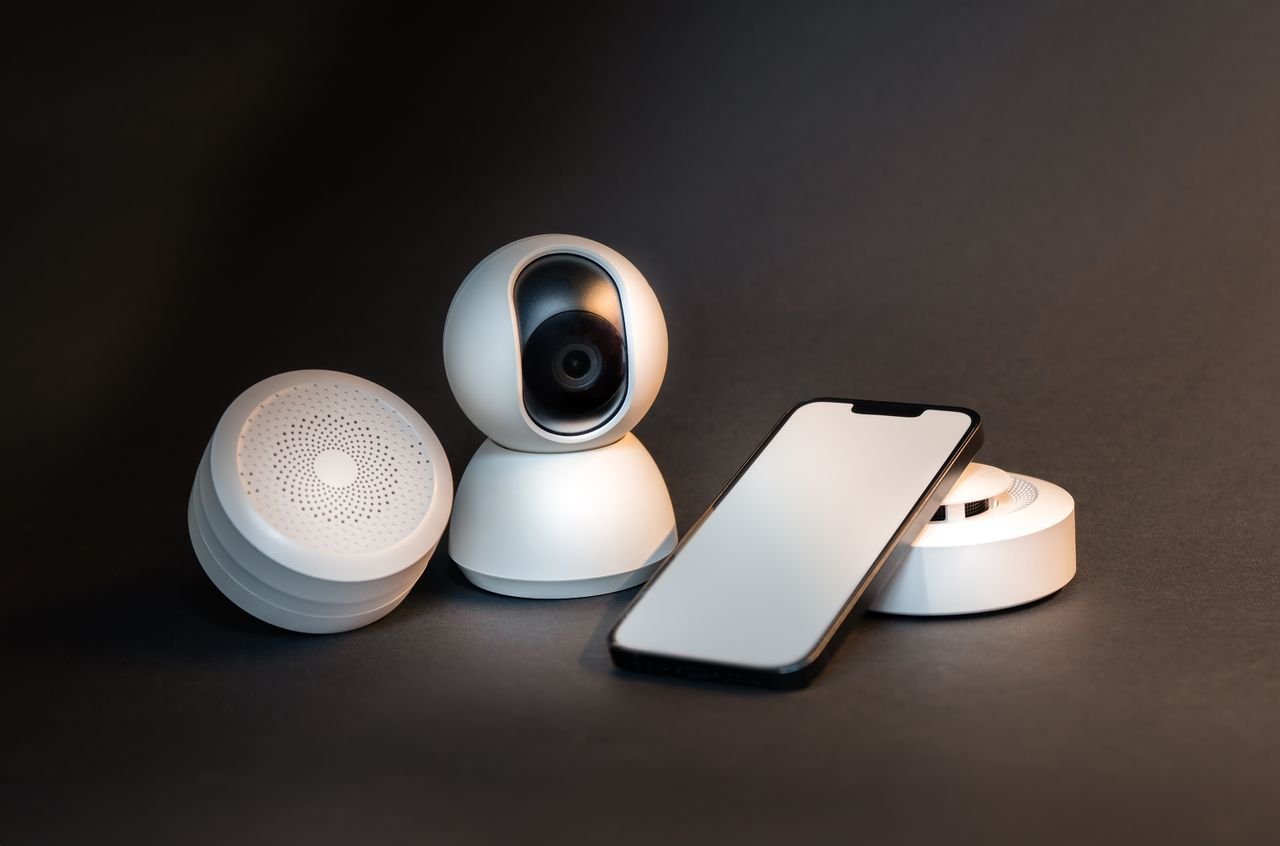 Crafting Captivating Headlines: Your awesome post title goes here A sleek smartphone with modern smart home devices on a minimalist gray background.